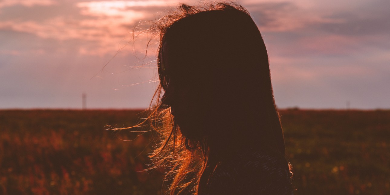 Silhouette of a person standing in the sun