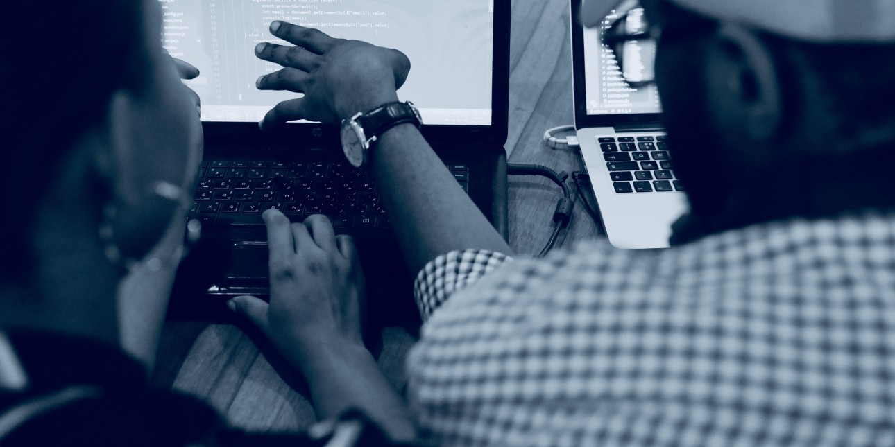 Two people working on computers