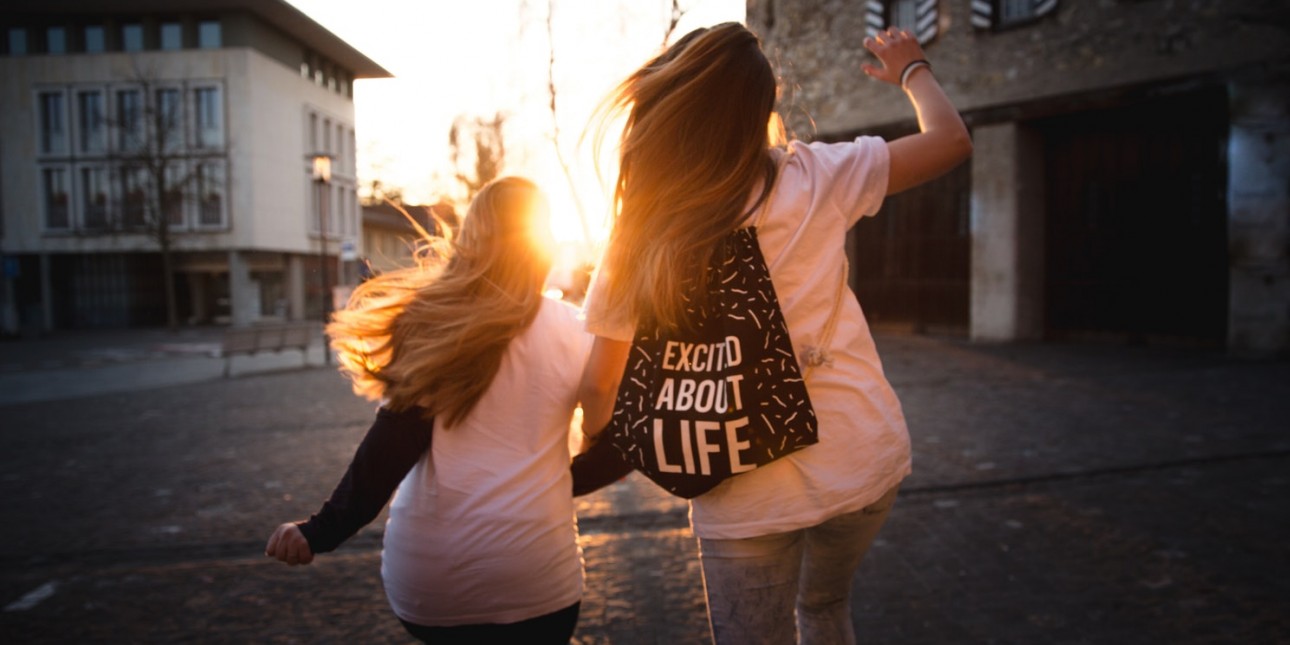 Positive Youth Development - Two girls dancing into the sunrise.