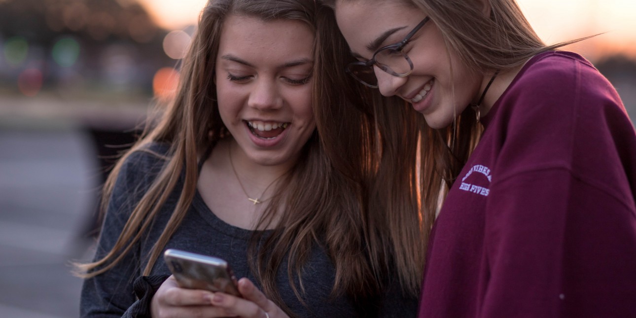 Two young people looking at a phone