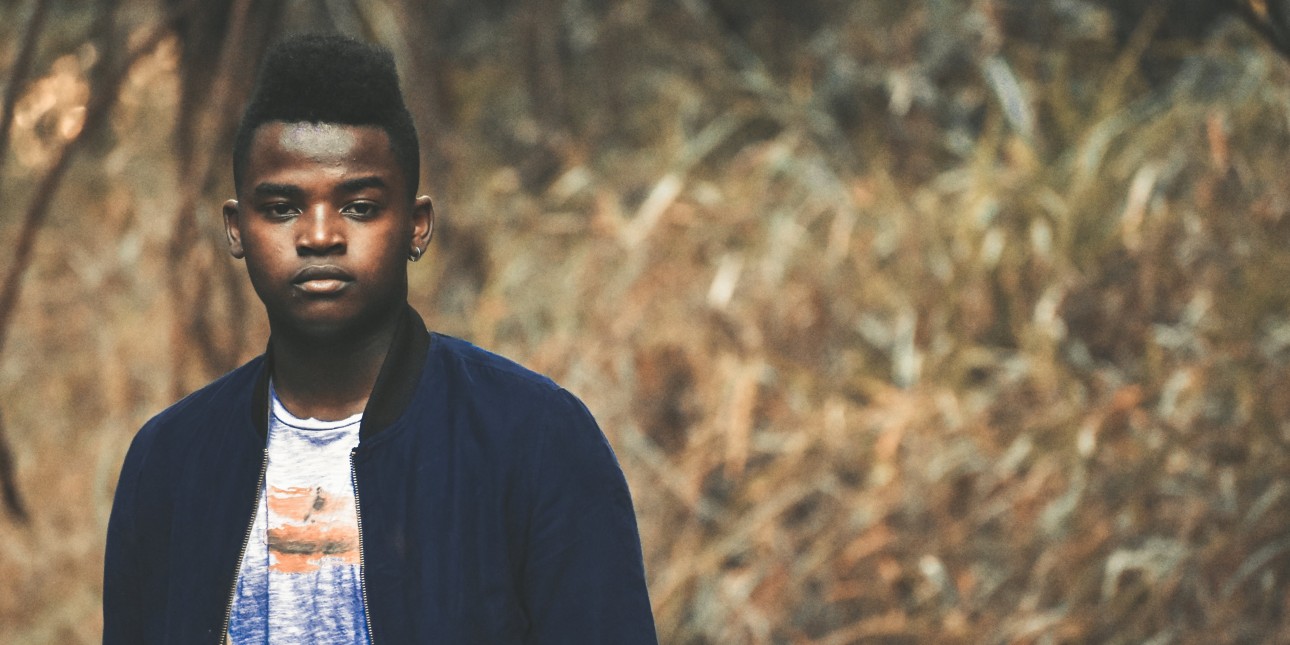 Young person standing in a meadow