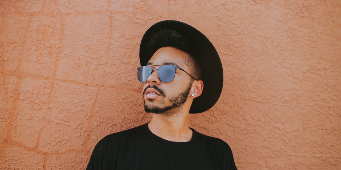 young person wearing hat and sunglasses