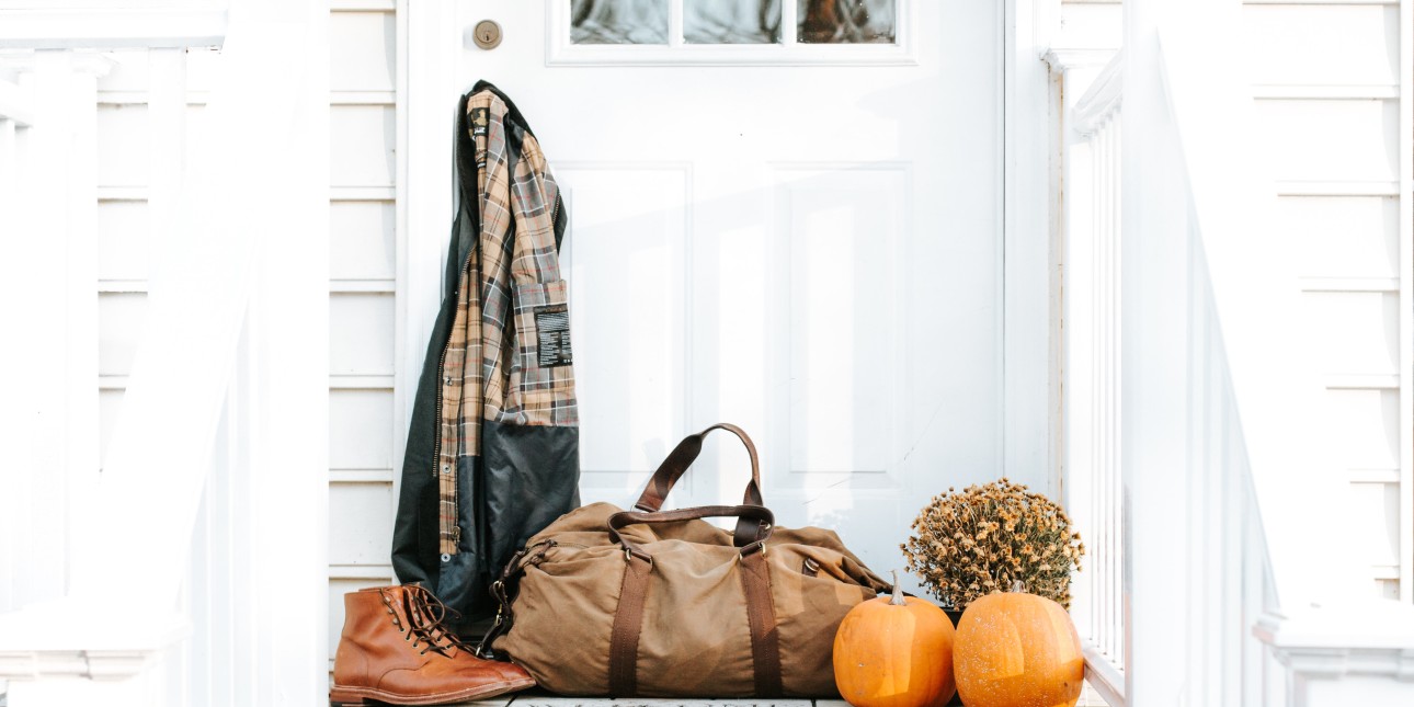 bag, shoes, jacket, and pumpkins on a doorstep