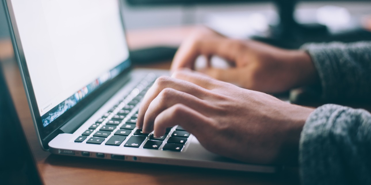 person typing on a laptop