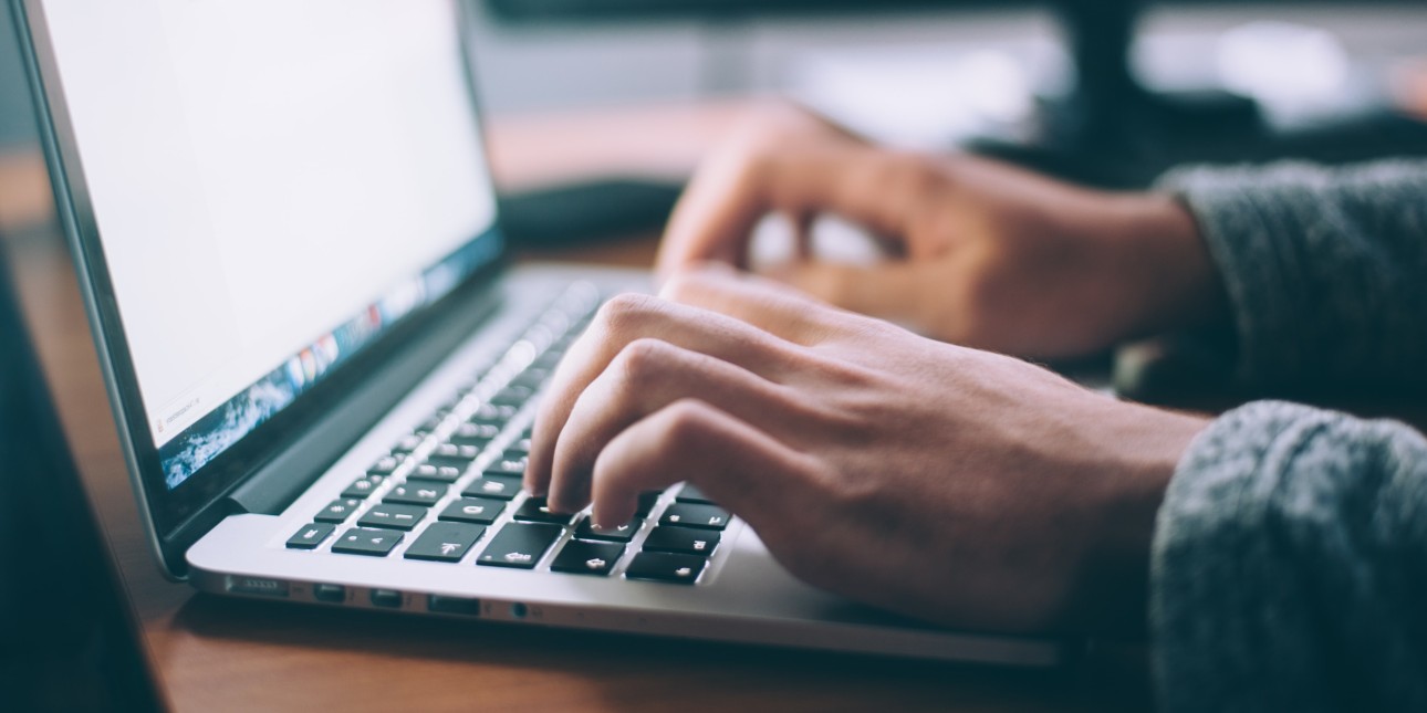 person typing on a laptop 