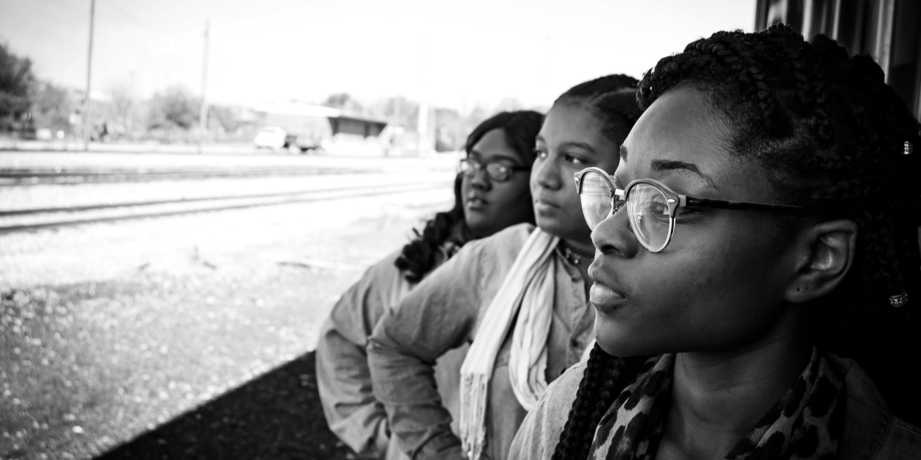 three black girls looking to the distance