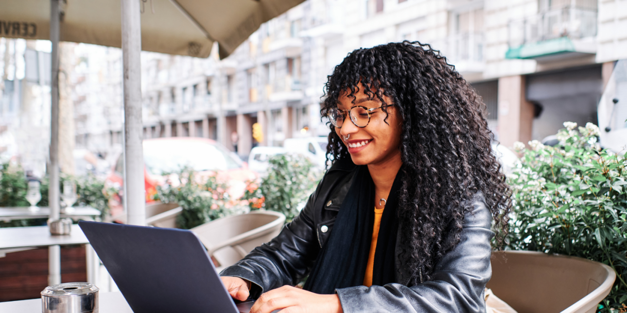 black woman typing on a laptop