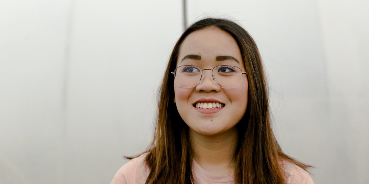 young person smiling wearing glasses
