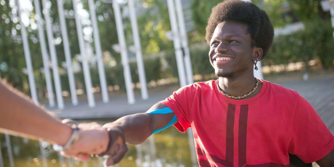 young black man fist bumping and smiling