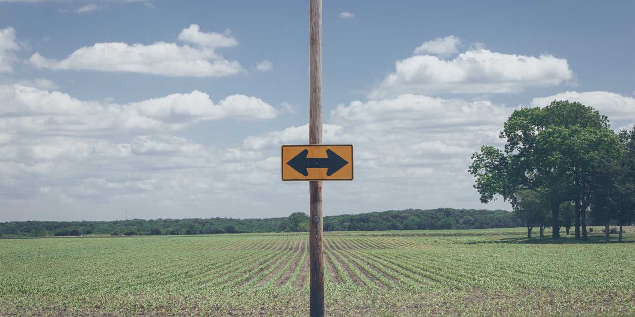 rural street sign with arrows