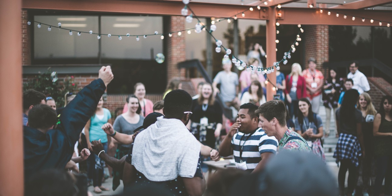 Group of young adults smiling on a patio