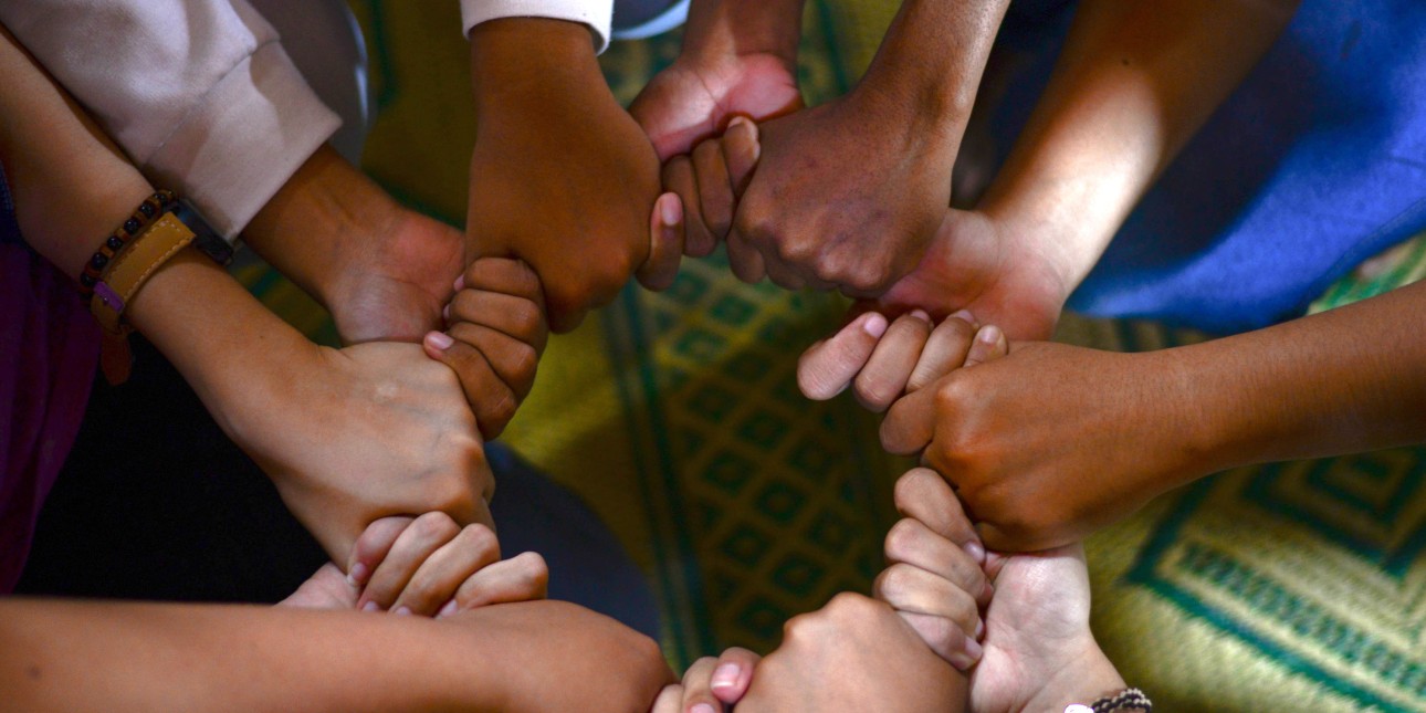 circle of people holding hands