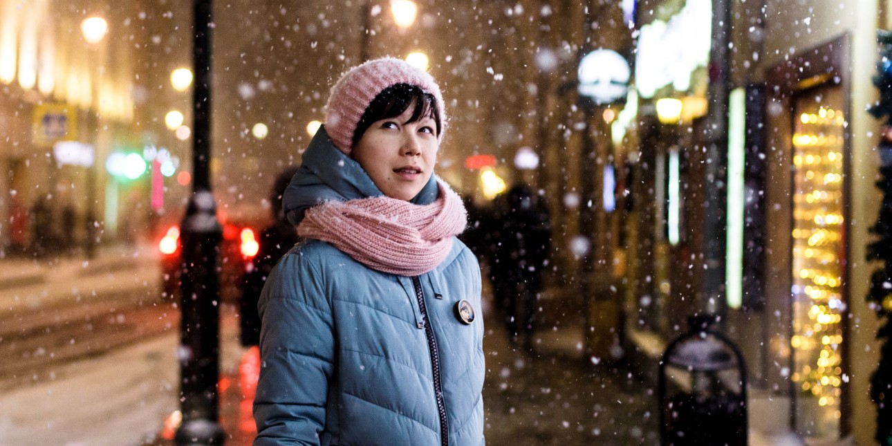 Person standing outside during a snowfall