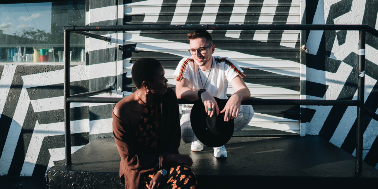 two young people sitting and conversing