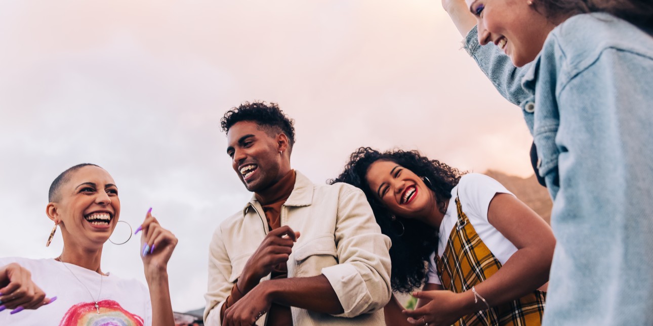 group of young people outside laughing