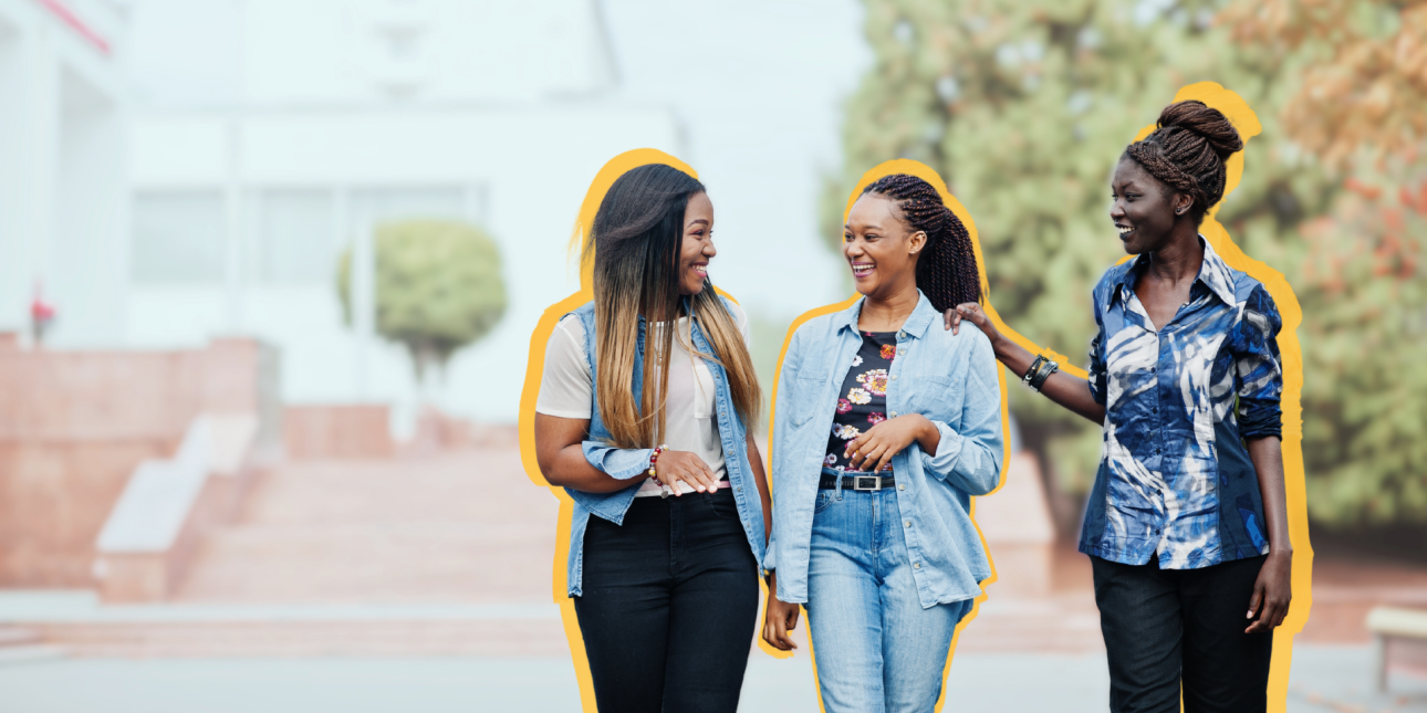 Three Black women walking and talking together.