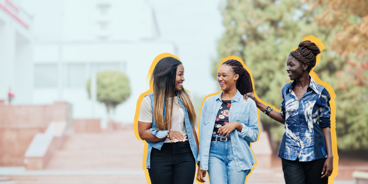 Three Black women walking and talking together.