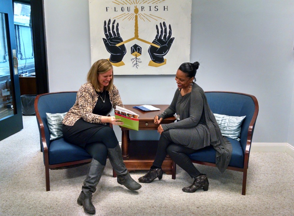 Two people sitting in chairs talking