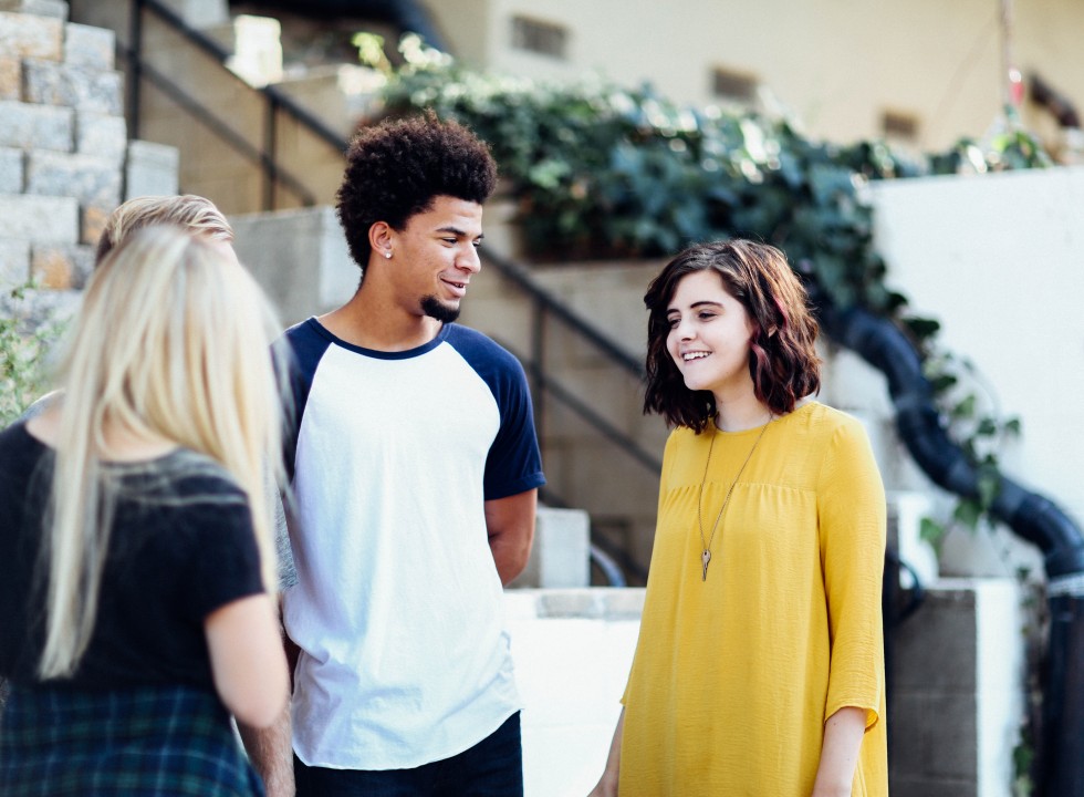 Young people standing talking 