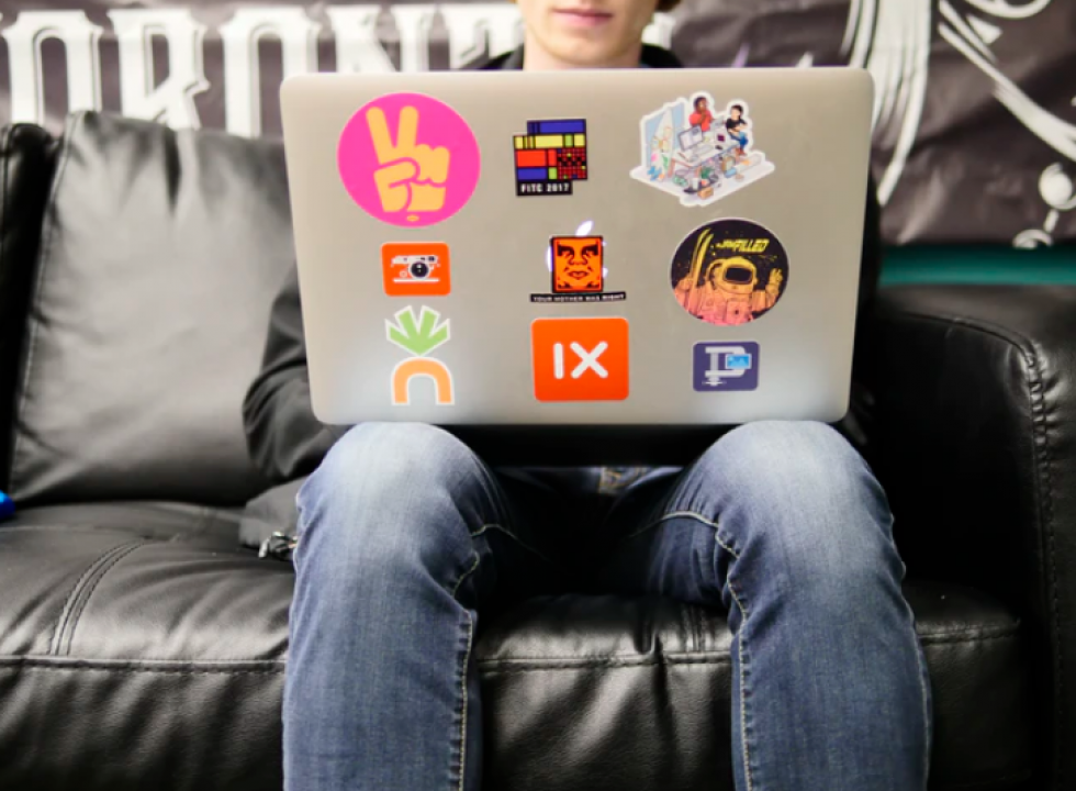 boy at computer with stickers