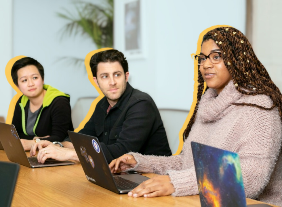 people sitting together with laptops open
