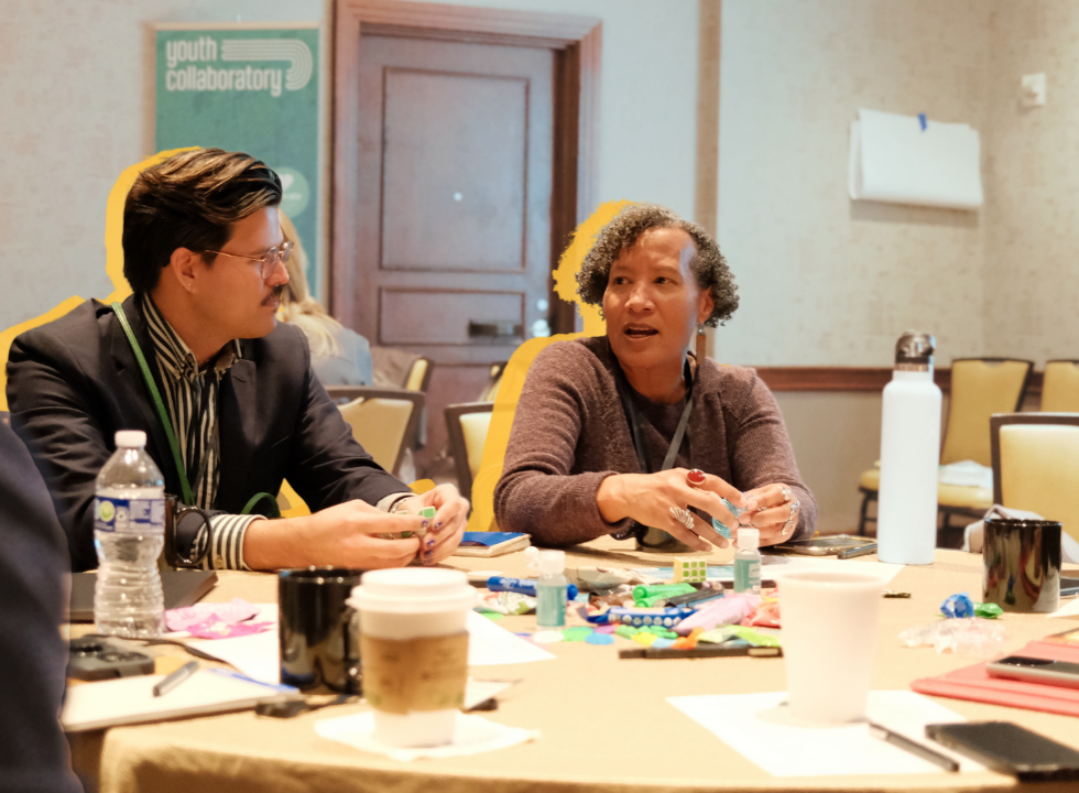 two attendees talking at a Youth Collaboratory event