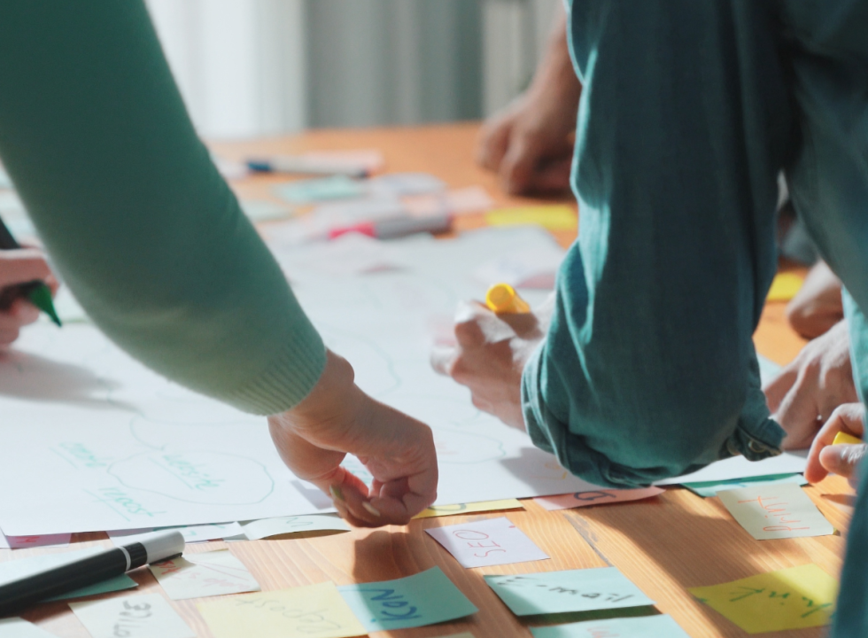 People huddled around a table making notes