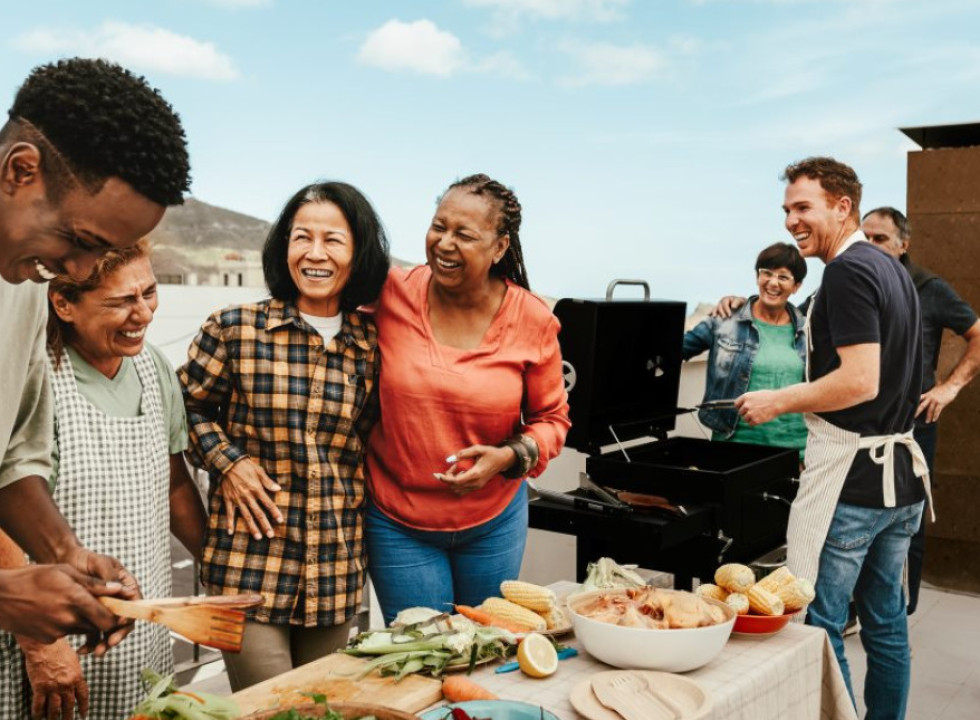 An intergenerational group enjoying a rooftop barbeque