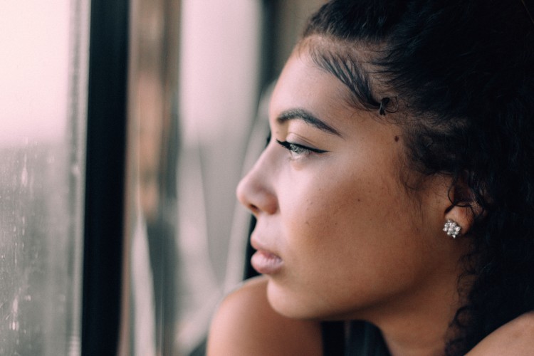 Woman looking out window