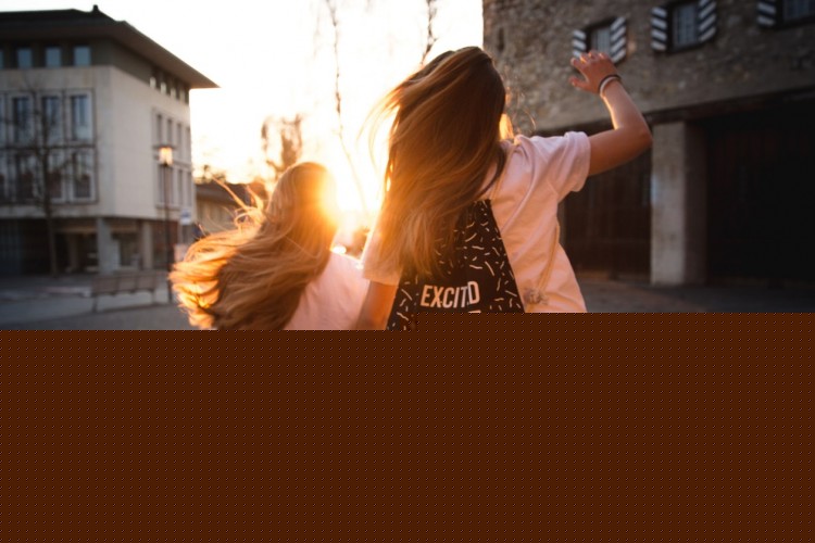 Positive Youth Development - Two girls dancing into the sunrise.