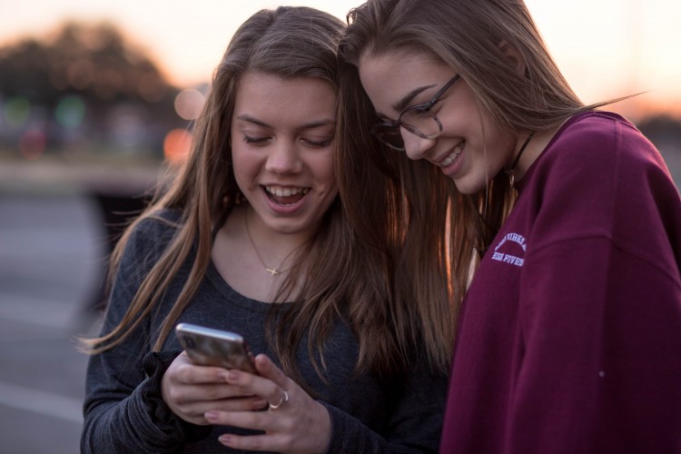 Two young people looking at a phone