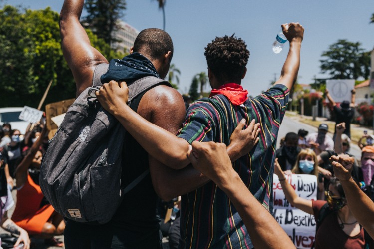 two men in solidarity at a protest