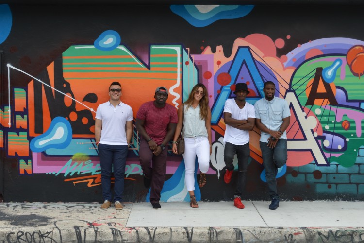 People standing against a wall