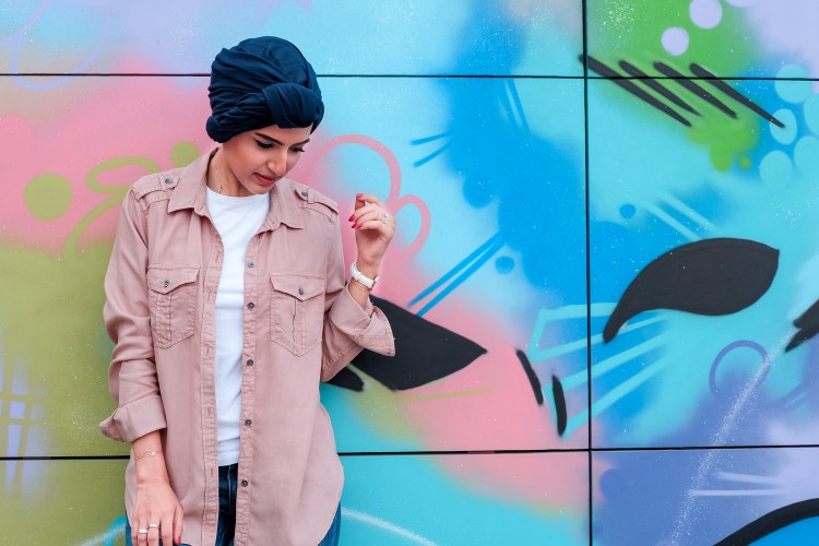 Person standing near mural