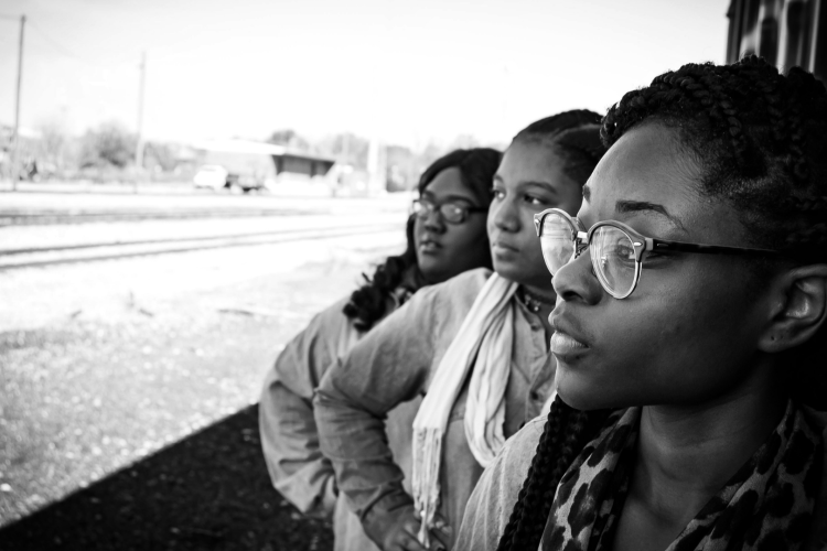 three black girls looking to the distance