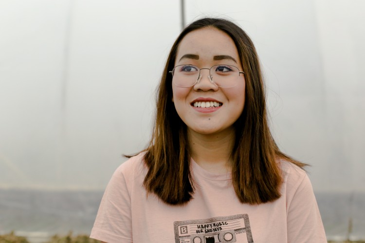 young person smiling wearing glasses