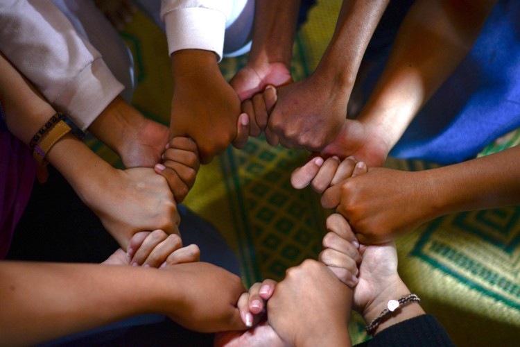 circle of people holding hands