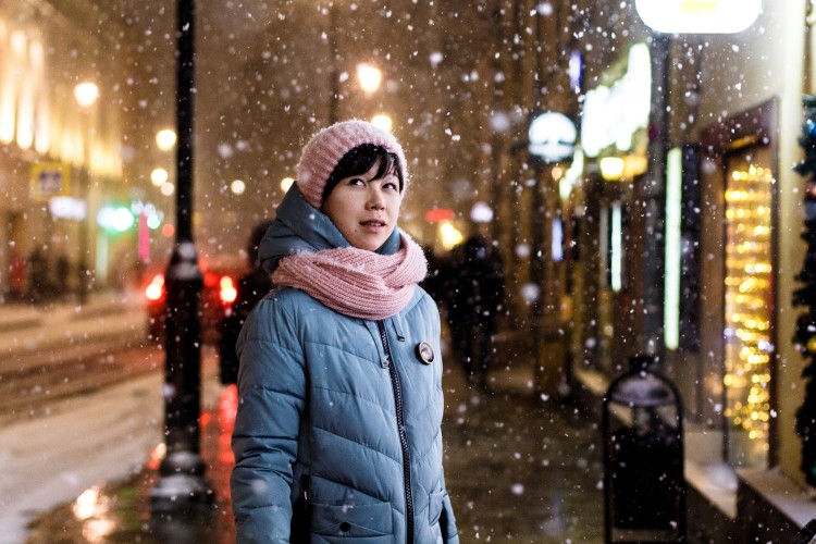 Person standing outside during a snowfall