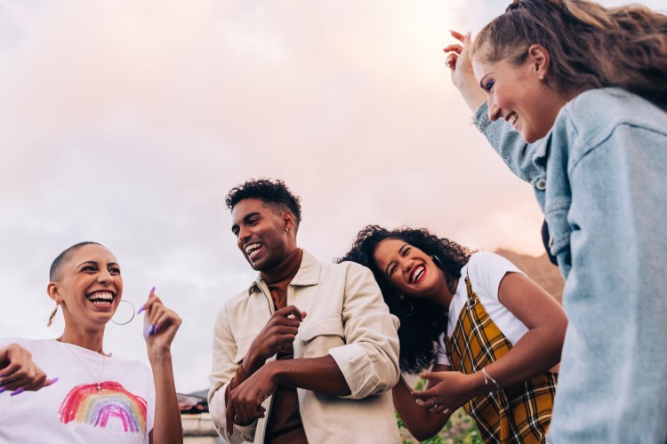 group of young people outside laughing